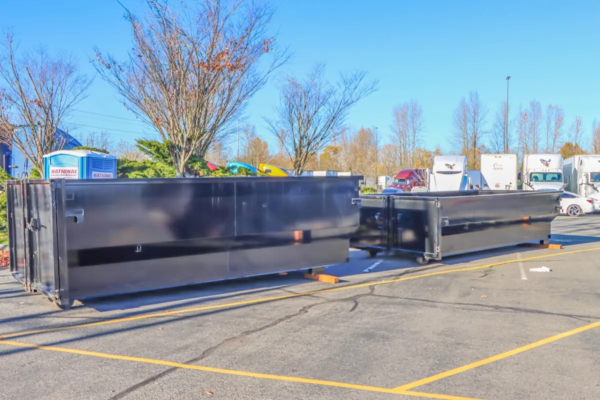 Professional dumpster rental service with roll-off container on residential driveway in Santa Ana